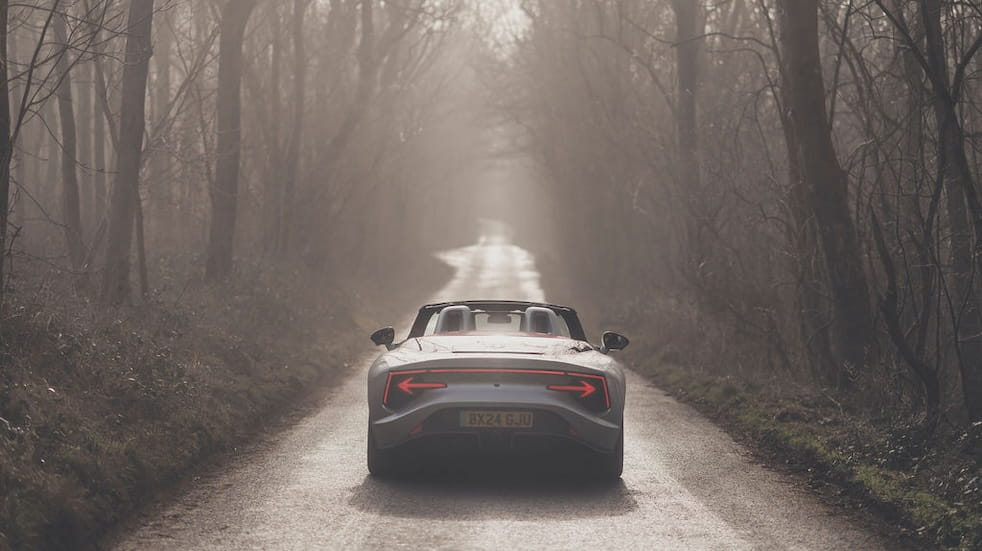 View of the back of the MG Cyberster going along a quiet country road